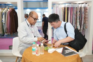 A vibrant flow of visitors, buyers, and industry professionals across the exhibition halls at Bharat Tex 2026, reflecting the event's strong international participation.